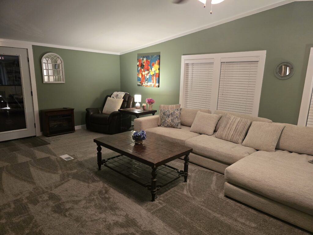 Living room filled with calm light and soft green walls, reflecting a new year focused on intention rather than pressure